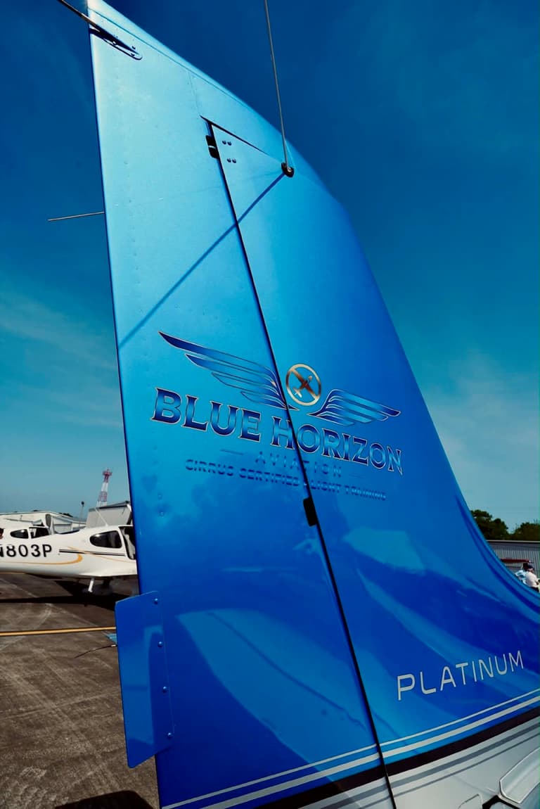 The Blue Horizon Aviation logo painted on the blue tail fin of one of the school’s Cirrus aircraft