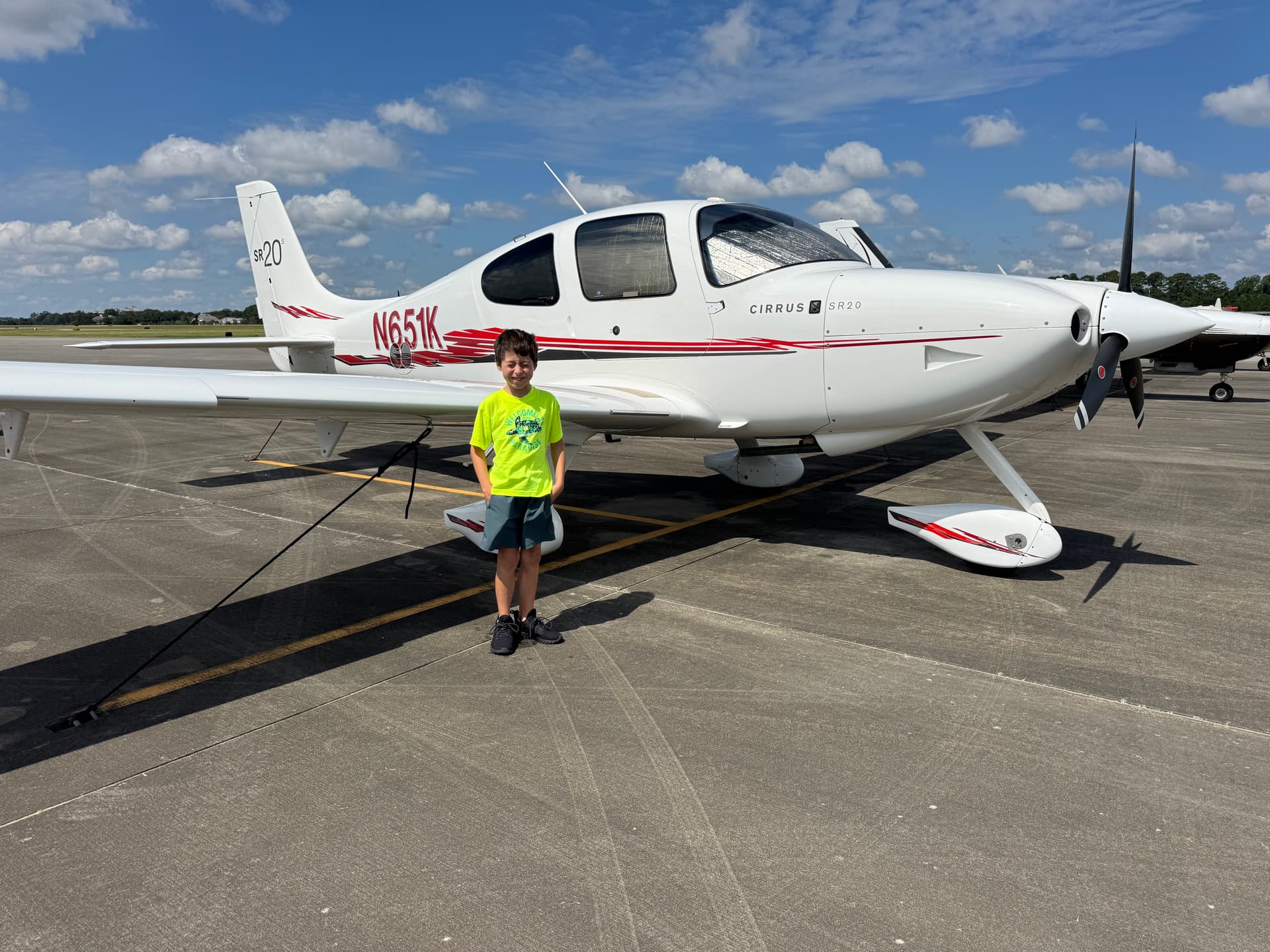A white and red Cirrus SR20, registration N651K, parked on the ramp at Grand Strand Airport