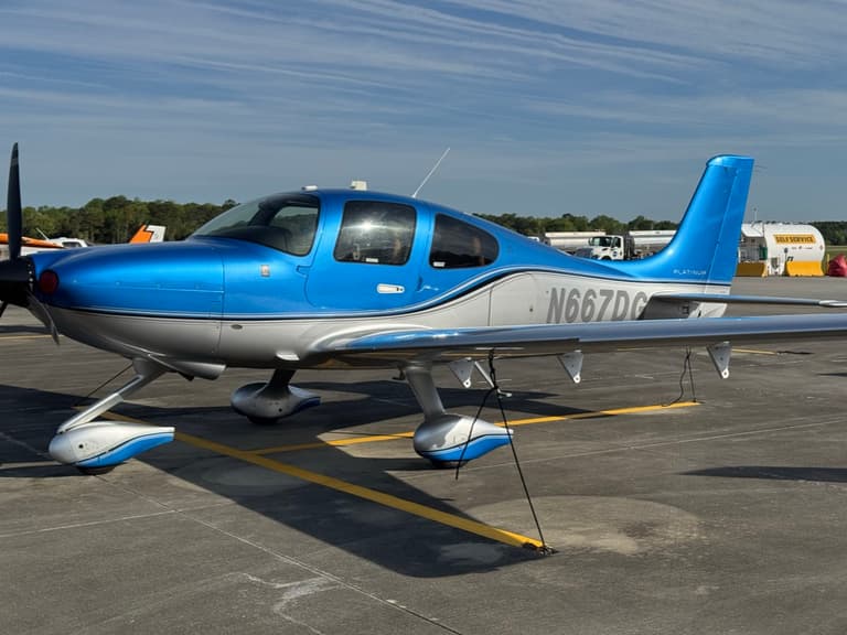 Cirrus SR20 G6 N667DG, in blue and silver, parked on the ramp at Grand Strand Airport